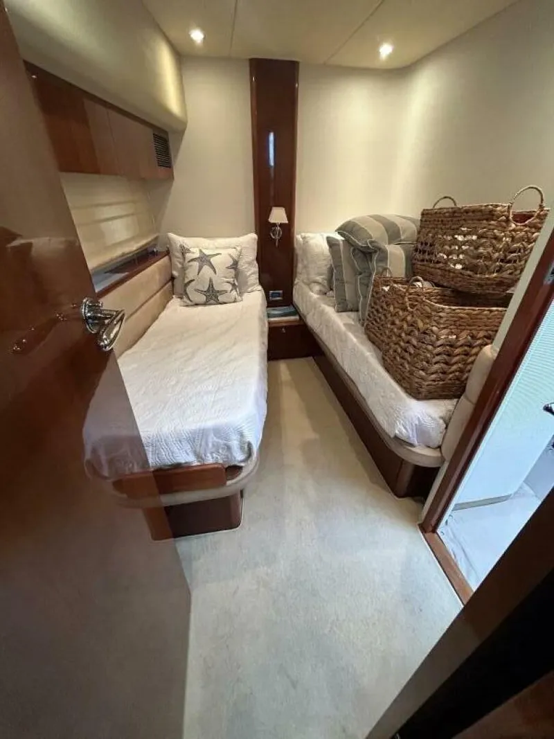 Slide: The Image of 2008 Princess 67 Flybridge cabin with twin beds and wicker baskets. - 31