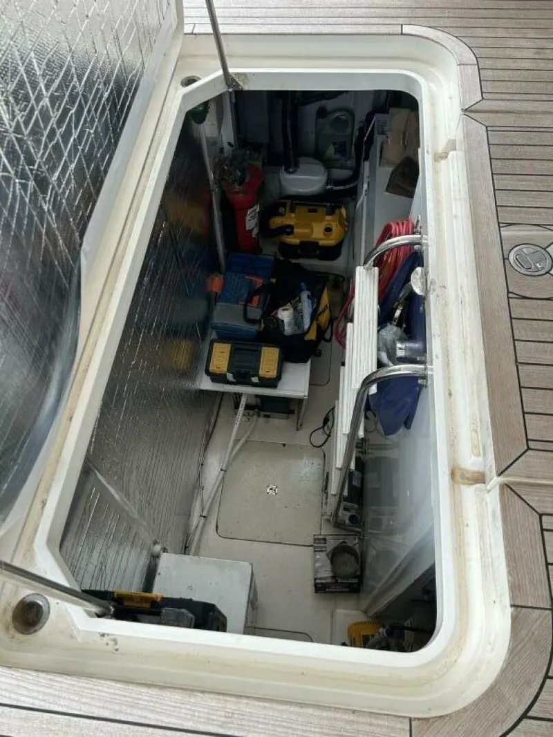 Slide: The Image of Engine compartment of 2008 Princess 67 Flybridge yacht, showcasing equipment and storage. - 33