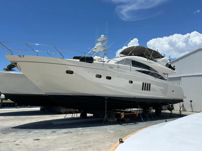 Slide: The Image of 2008 Princess 67 Flybridge yacht on dry dock under clear blue sky. - 37