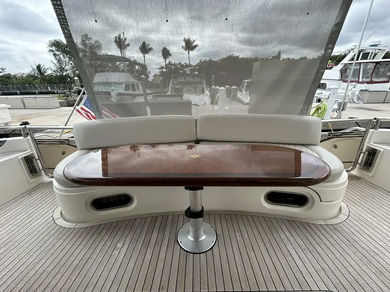 Slide: The Image of Luxury seating area on 2008 Princess 67 Flybridge yacht with wooden table. - 7
