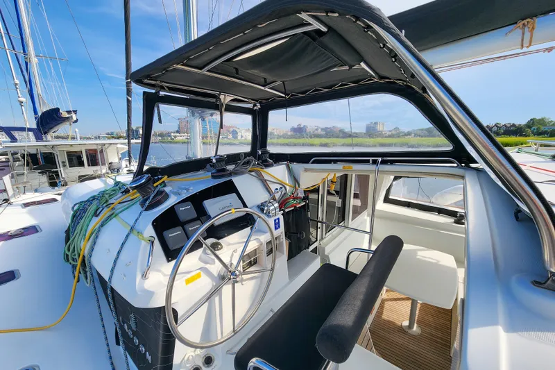 Slide: The Image of Cockpit of 2012 Lagoon 400 catamaran with steering wheel and navigation equipment. - 11
