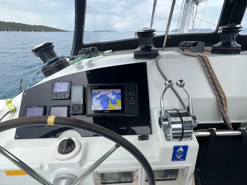 Slide: The Image of Cockpit of 2012 Lagoon 400 catamaran with navigation equipment and steering wheel. - 12