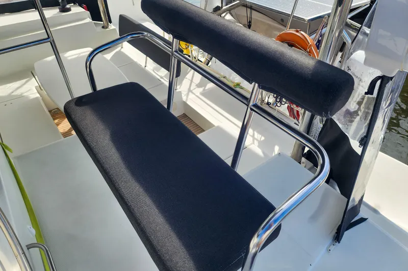 Slide: The Image of Helm seat on 2012 Lagoon 400 catamaran with stainless steel frame and black cushions. - 13