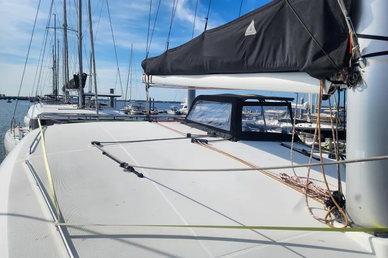 Slide: The Image of 2012 Lagoon 400 catamaran docked at marina under clear blue sky. - 15