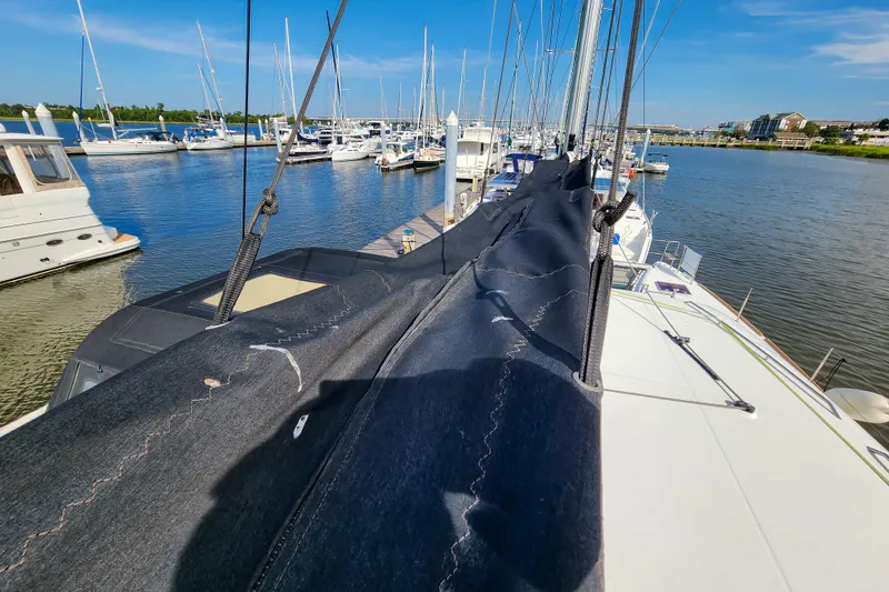 Slide: The Image of 2012 Lagoon 400 catamaran docked at marina, surrounded by other boats under clear blue sky. - 18