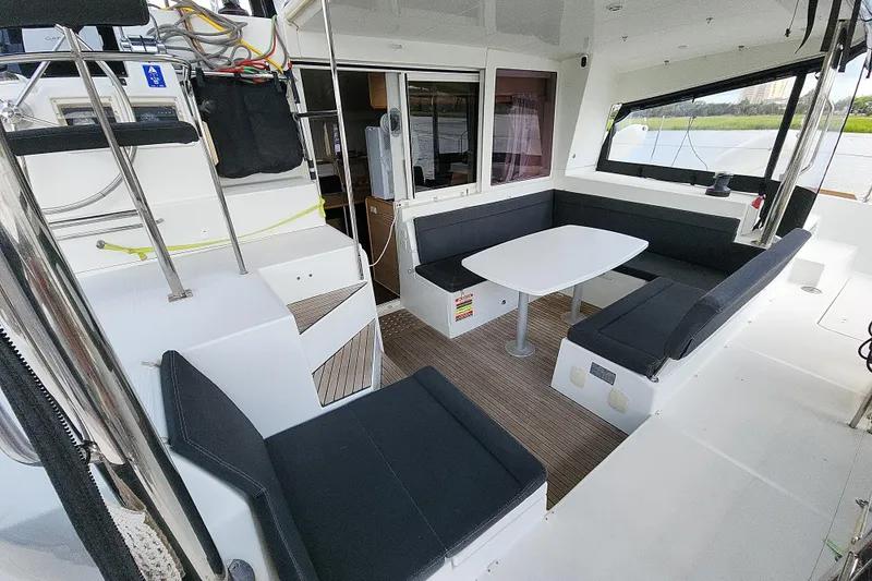 Slide: The Image of Spacious 2012 Lagoon 400 yacht cockpit with seating and table, featuring modern design. - 19