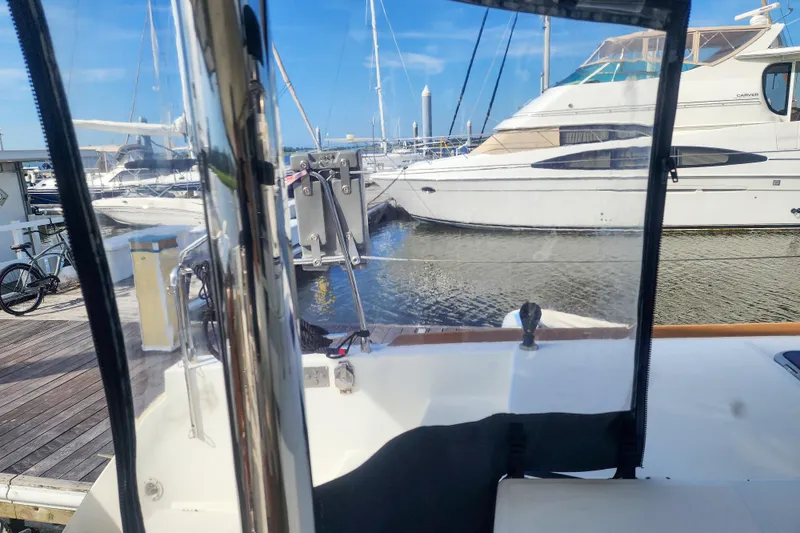 Slide: The Image of View from Lagoon 400 catamaran, docked at marina with other boats, clear blue sky. - 22