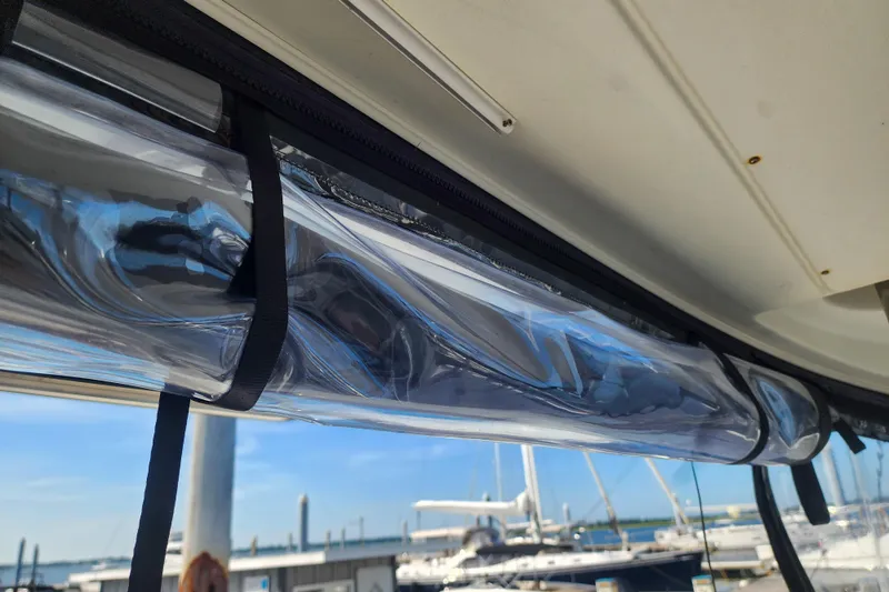 Slide: The Image of Clear plastic window on a 2012 Lagoon 400 catamaran, marina background. - 23