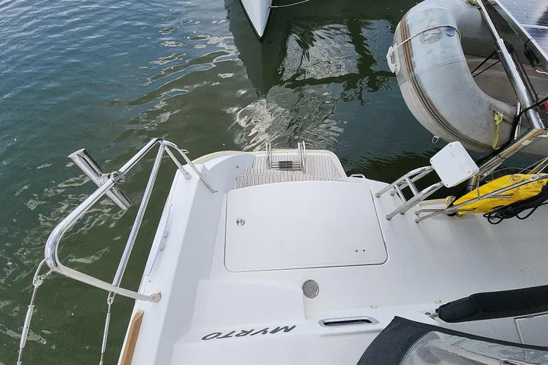 Slide: The Image of Lagoon 400 catamaran stern view with dinghy and water reflection, 2012 model. - 24