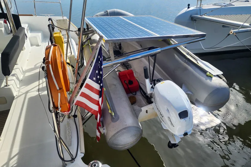 Slide: The Image of Lagoon 400 catamaran (2012) with solar panel, dinghy, and American flag on deck. - 25