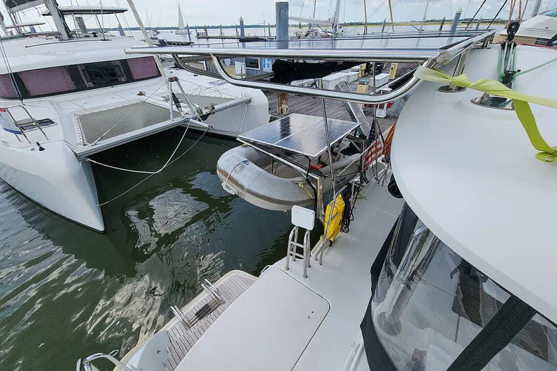 Slide: The Image of Docked Lagoon 400 catamaran from 2012 with solar panels and dinghy. - 26