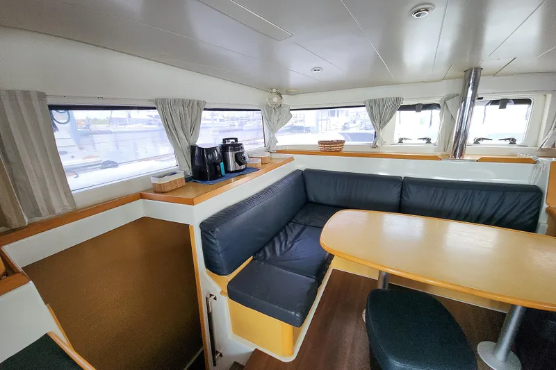 Slide: The Image of Interior of 2012 Lagoon 400 catamaran with cozy seating and dining area. - 28