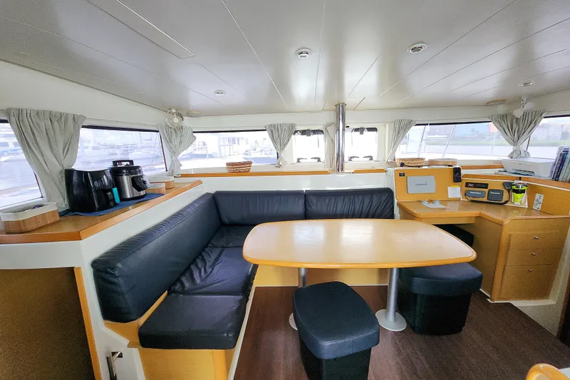 Slide: The Image of Interior of 2012 Lagoon 400 catamaran with dining area and navigation station. - 29