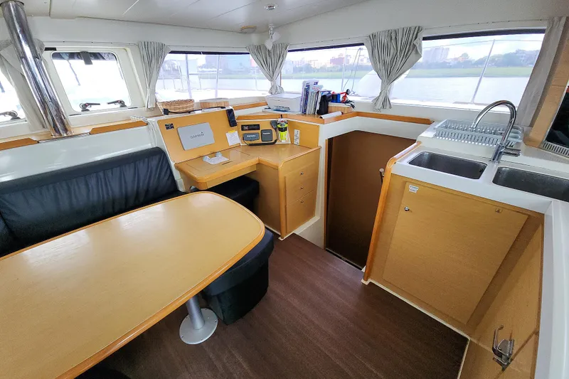 Slide: The Image of Interior of a 2012 Lagoon 400 catamaran with dining area and kitchen. - 30