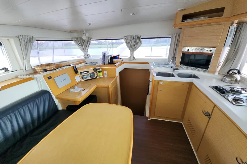 Slide: The Image of Interior of 2012 Lagoon 400 catamaran featuring kitchen and navigation area. - 32