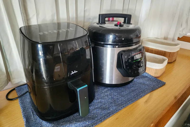 Slide: The Image of Air fryer and pressure cooker on a wooden countertop in a Lagoon 400, 2012 model. - 33