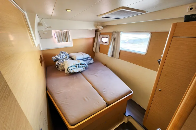 Slide: The Image of Cozy cabin interior of 2012 Lagoon 400 catamaran with double bed and windows. - 36