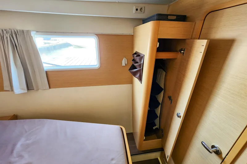 Slide: The Image of Interior cabin of 2012 Lagoon 400 yacht with open wardrobe and window. - 37