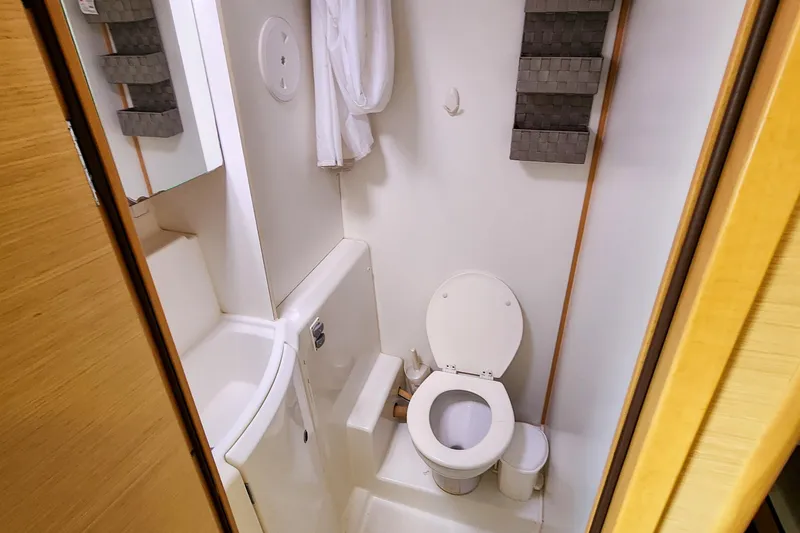 Slide: The Image of Compact bathroom in a 2012 Lagoon 400 yacht, featuring a toilet and sink. - 38