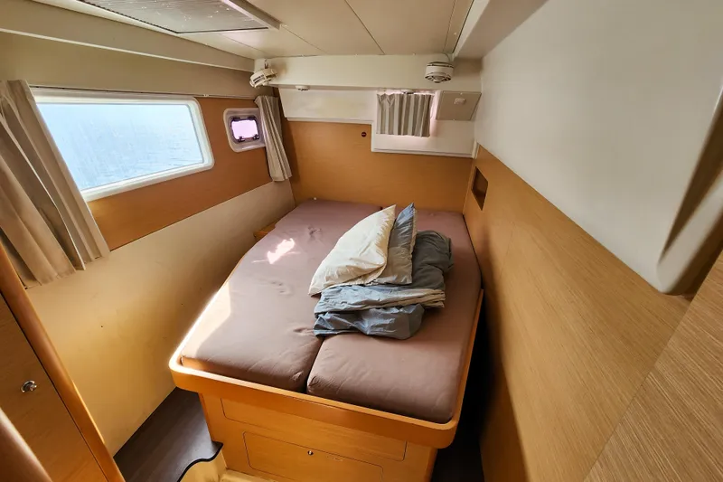 Slide: The Image of Cozy cabin interior of 2012 Lagoon 400 catamaran with bed and windows. - 39