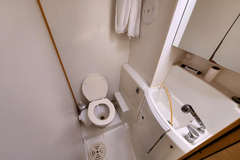 Slide: The Image of Compact bathroom in a 2012 Lagoon 400 yacht, featuring a toilet and sink. - 40