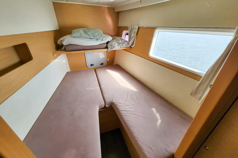Slide: The Image of Interior cabin of a 2012 Lagoon 400 catamaran with cozy bedding and window view. - 41