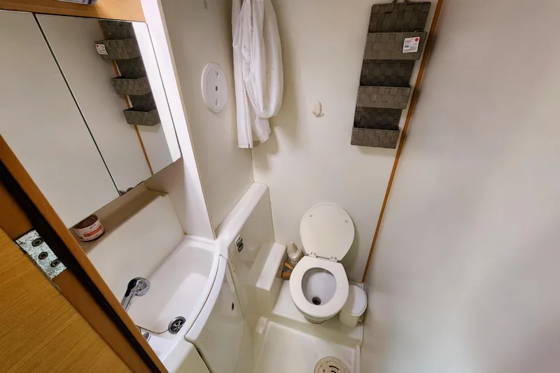 Slide: The Image of Compact bathroom in a 2012 Lagoon 400 yacht, featuring a toilet and sink. - 42