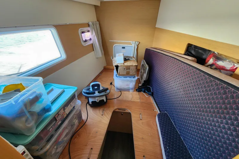 Slide: The Image of Interior cabin of 2012 Lagoon 400 catamaran with storage boxes and equipment. - 43