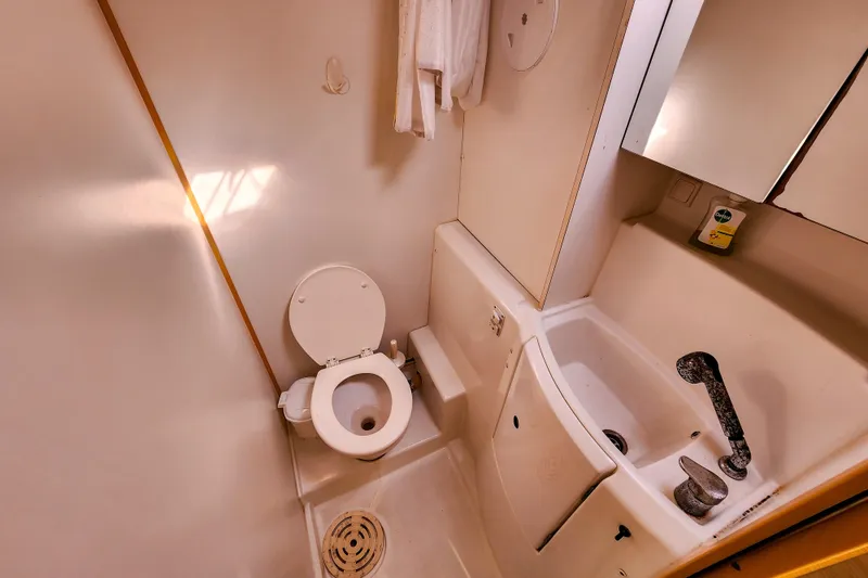 Slide: The Image of Compact bathroom in a 2012 Lagoon 400 yacht, featuring toilet and sink. - 44