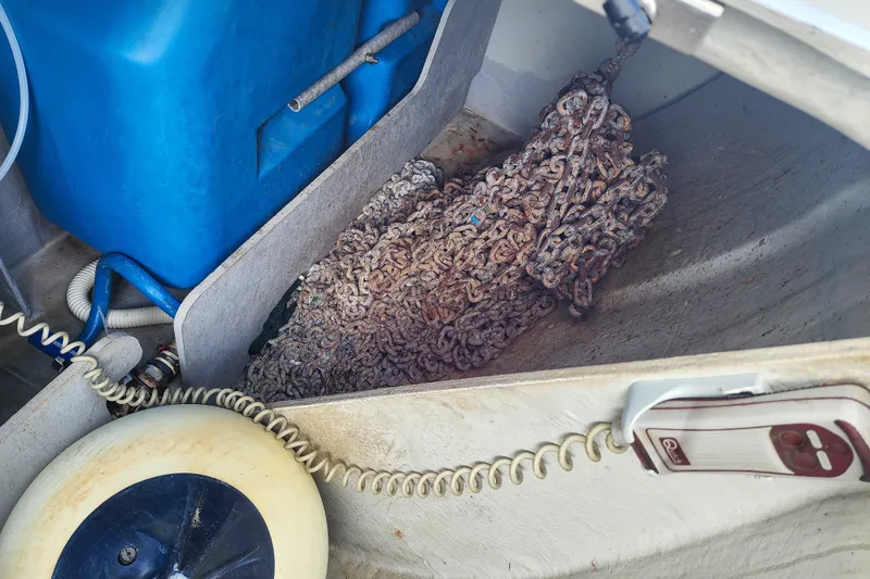 Slide: The Image of Anchor chain storage on 2012 Lagoon 400 catamaran with blue container and coiled rope. - 48