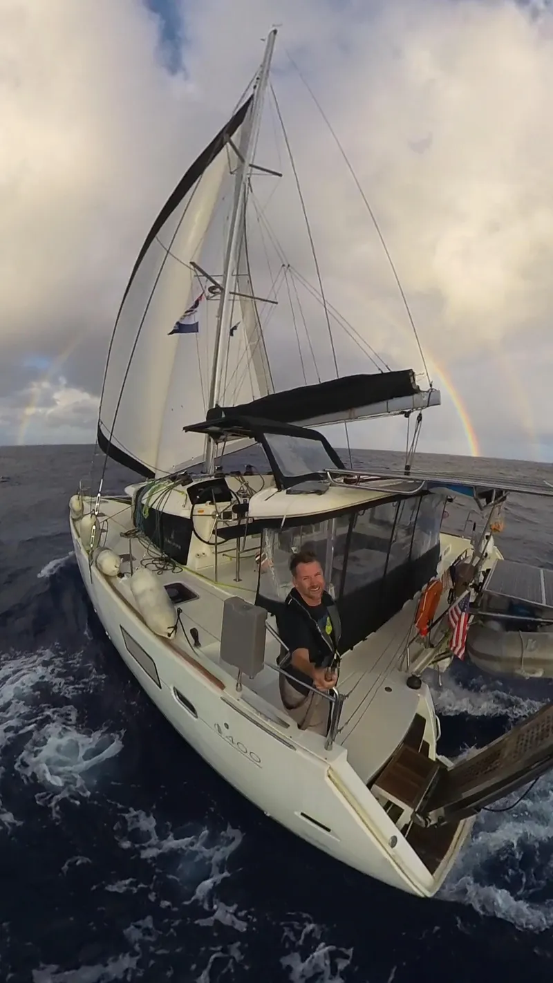 Slide: The Image of Sailing Lagoon 400 catamaran, 2012 model, on open sea with rainbow in background. - 51