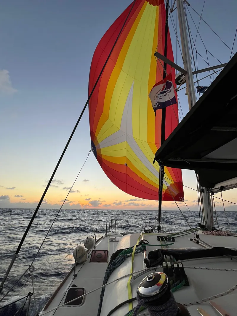 Slide: The Image of Lagoon 400 catamaran sailing at sunset with colorful spinnaker, 2012 model. - 53