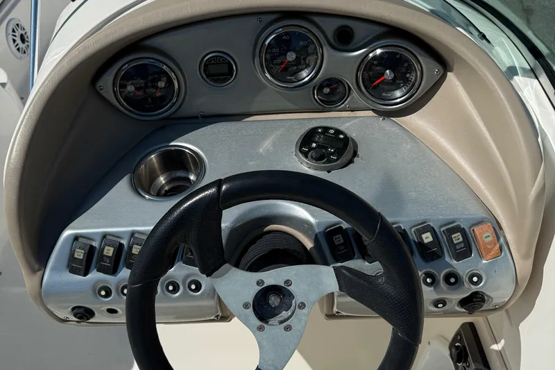 Slide: The Image of Dashboard of 2012 Hurricane SunDeck 217 OB boat with steering wheel and gauges. - 12