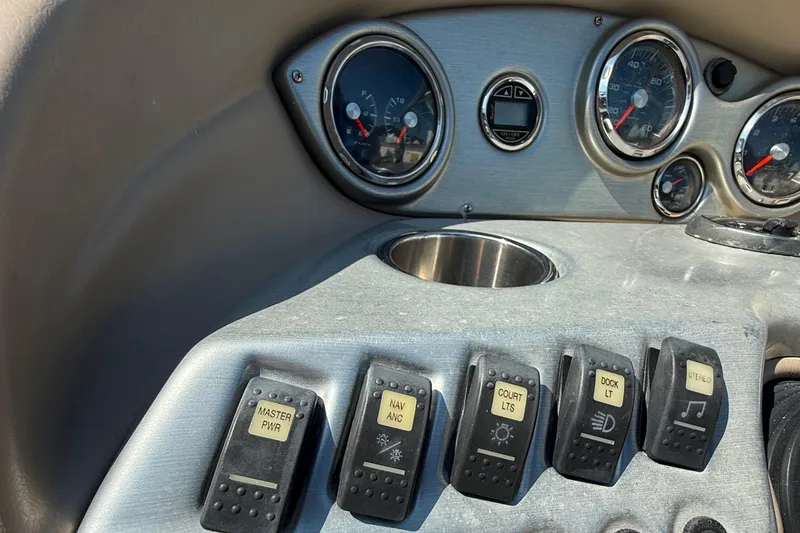 Slide: The Image of Control panel of a 2012 Hurricane SunDeck 217 OB boat with switches and gauges. - 13