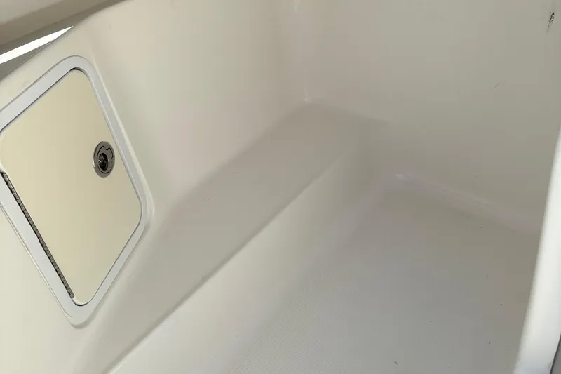 Slide: The Image of 2012 Hurricane SunDeck 217 OB interior storage compartment with white finish. - 16