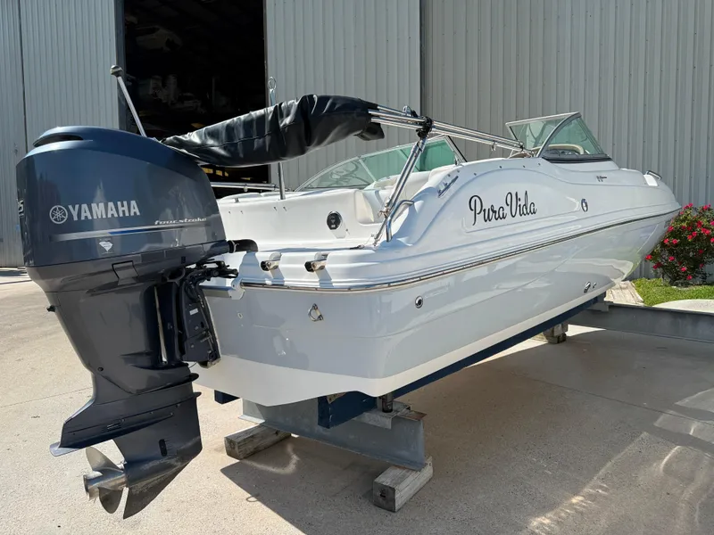 Slide: The Image of 2012 Hurricane SunDeck 217 OB boat with Yamaha outboard motor, displayed outdoors. - 2