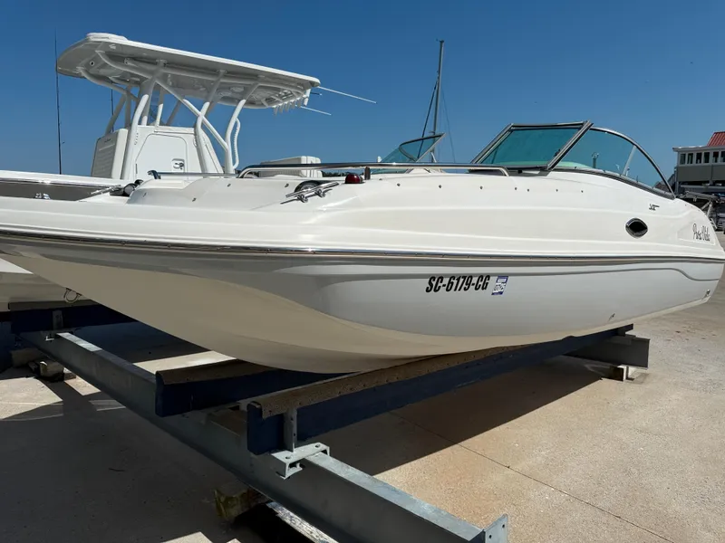 Slide: The Image of 2012 Hurricane SunDeck 217 OB boat on trailer, white exterior, sunny day. - 4
