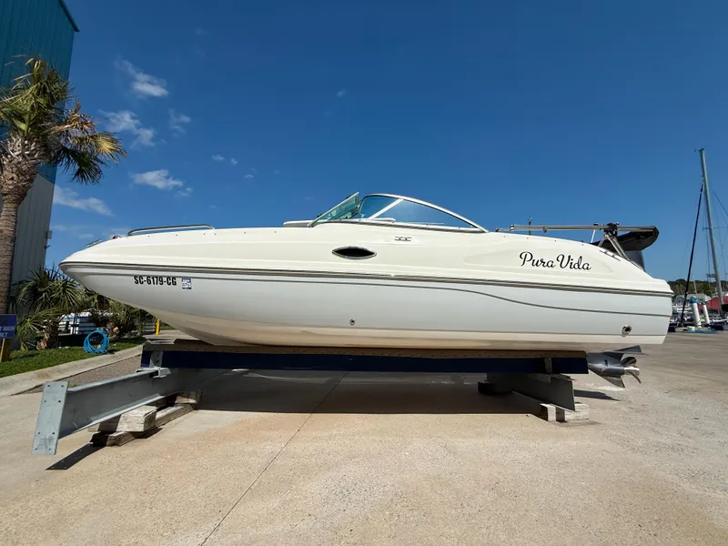 Slide: The Image of 2012 Hurricane SunDeck 217 OB boat on trailer under clear blue sky. - 6