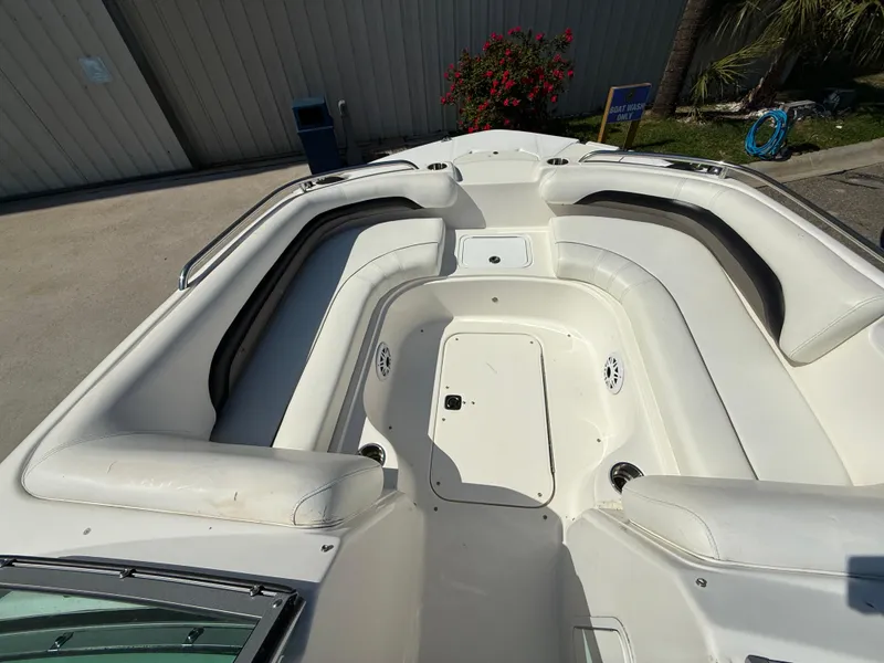 Slide: The Image of 2012 Hurricane SunDeck 217 OB boat interior with white seating and storage compartments. - 8