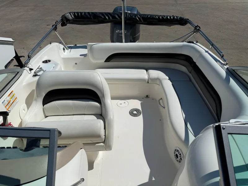 Slide: The Image of 2012 Hurricane SunDeck 217 OB boat interior with white seating and spacious layout. - 9