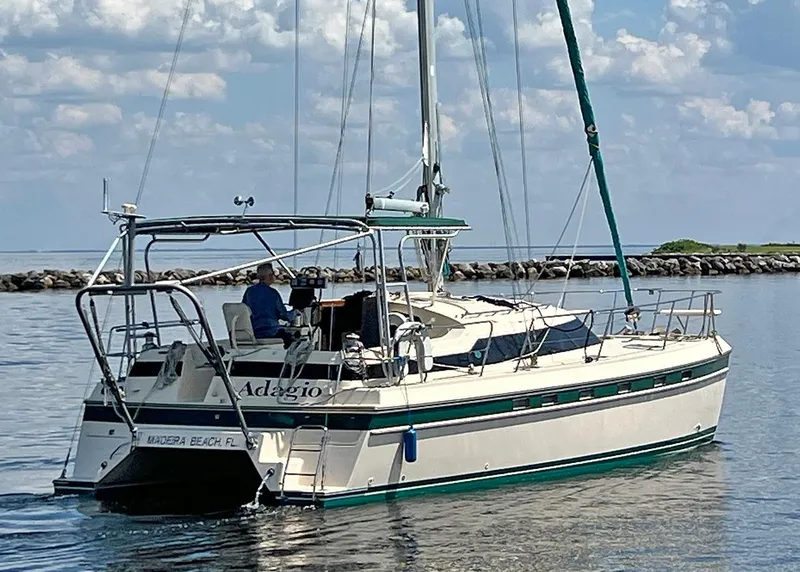 The Image of 1998 Island Packet Cat 35 sailboat on calm water, Madeira Beach, Florida. - 0