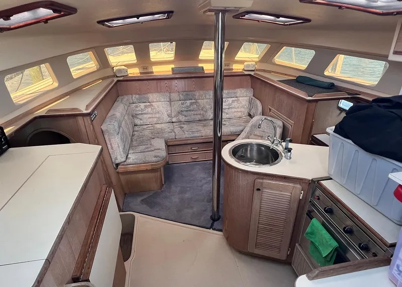 Slide: The Image of Interior of 1998 Island Packet Cat 35 sailboat with kitchen and seating area. - 11