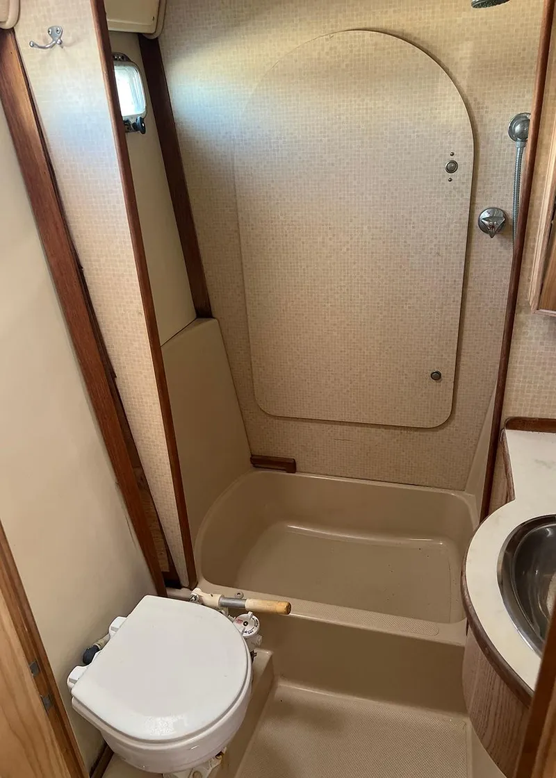 Slide: The Image of 1998 Island Packet Cat 35 bathroom with shower, toilet, and sink. - 17
