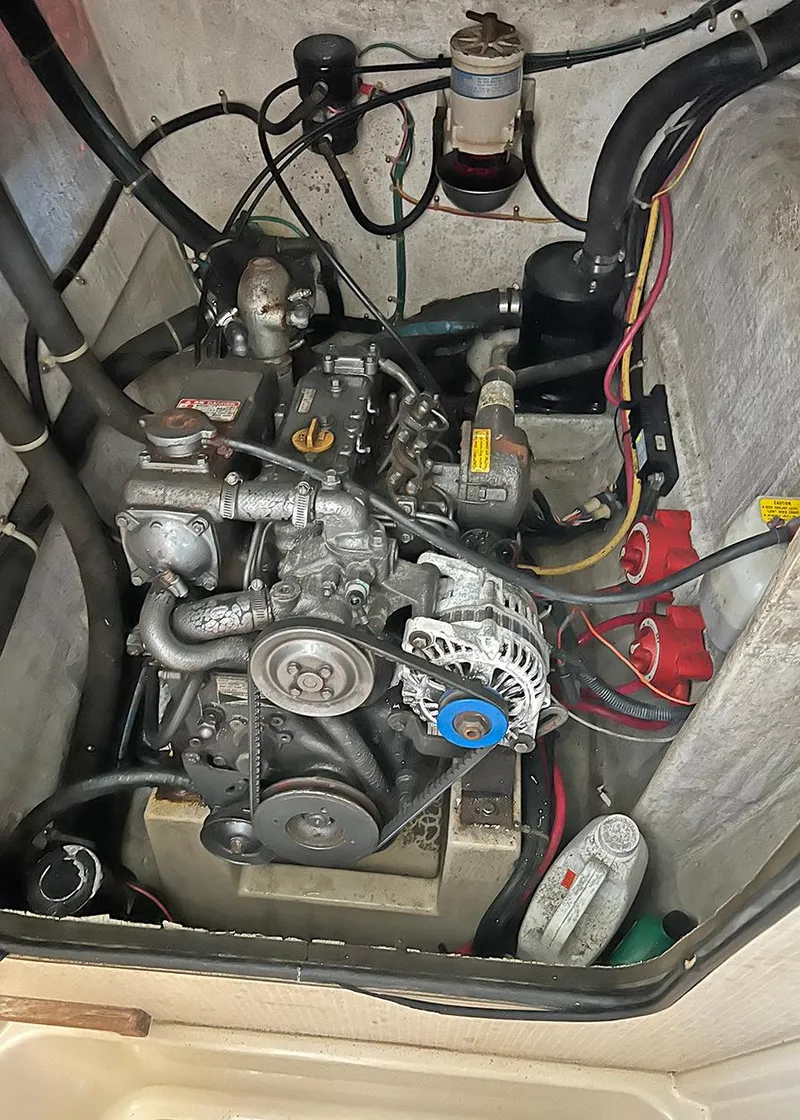 Slide: The Image of Engine compartment of a 1998 Island Packet Cat 35 sailboat, showing mechanical components. - 19
