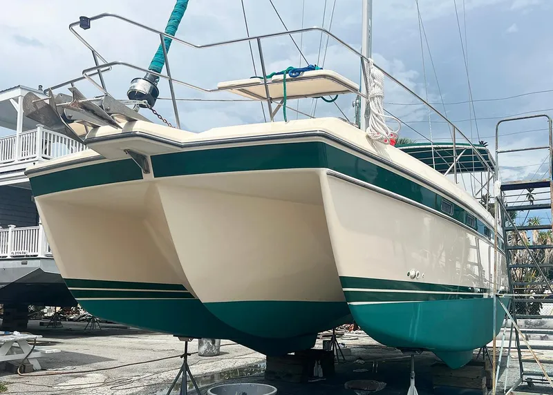 Slide: The Image of 1998 Island Packet Cat 35 catamaran on dry dock, showcasing its dual hull design. - 22