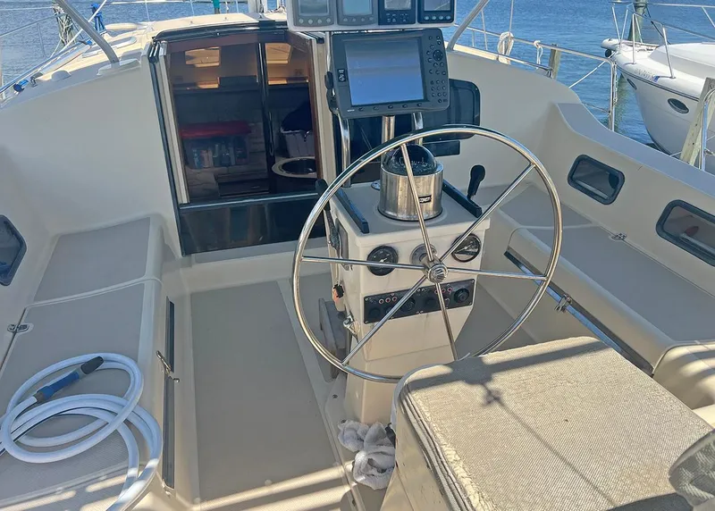 Slide: The Image of 1998 Island Packet Cat 35 cockpit with steering wheel and navigation equipment. - 3