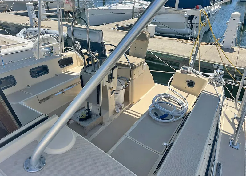 Slide: The Image of 1998 Island Packet Cat 35 sailboat cockpit with marina background. - 4