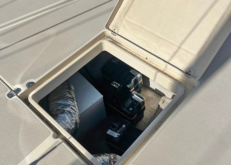 Slide: The Image of Open hatch on 1998 Island Packet Cat 35, revealing interior storage compartment. - 6