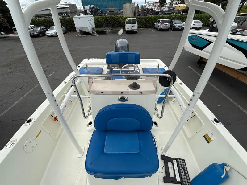 Slide: The Image of 2008 Sailfish 1900 BB Bay Boat with blue seating, parked in a lot. - 10