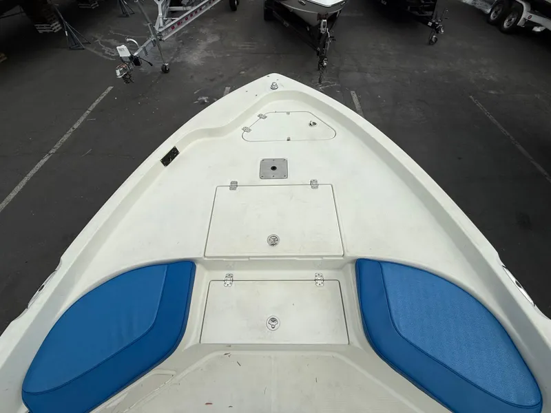 Slide: The Image of 2008 Sailfish 1900 BB Bay Boat deck with blue seating and storage compartments. - 11